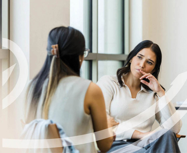 Woman sitting at desk looking stressed