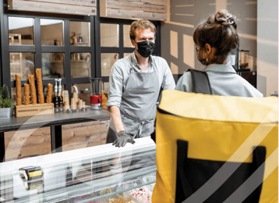 Two people standing and having a conversion in a hospitality setting.