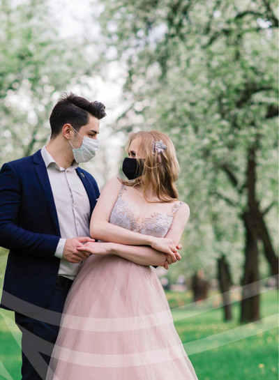 Masked couple in formal attire outdoors