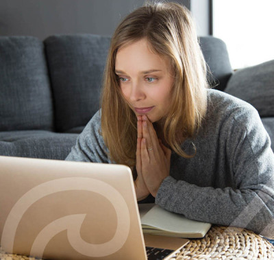 Woman looking distressed at laptop