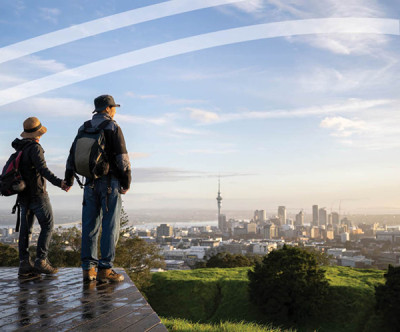 Couple looking at Auckland skyline from Mount Eden.