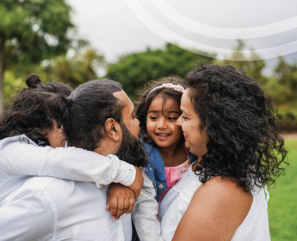 Photo of a multi-generational family embracing and smiling