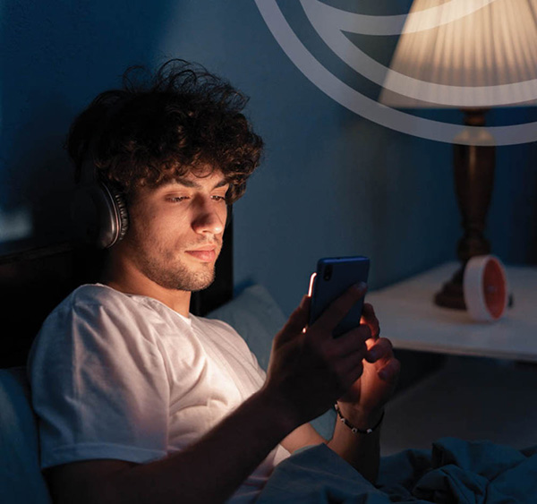 Person looking at phone in dim lighting