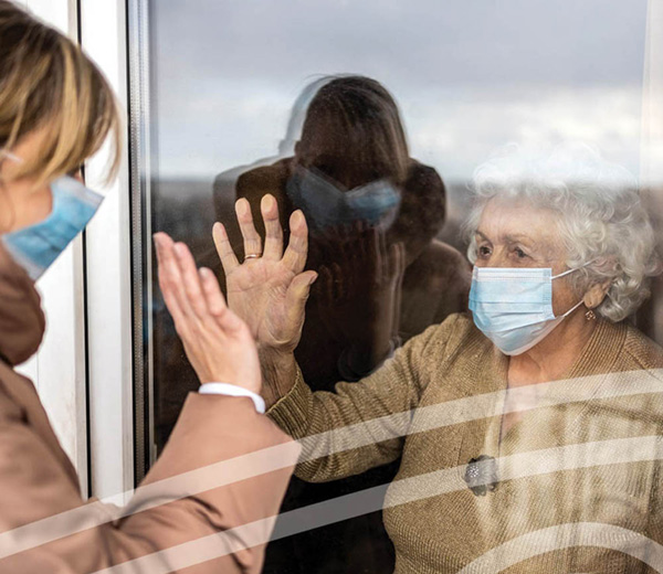 Person looking through window at another person outside