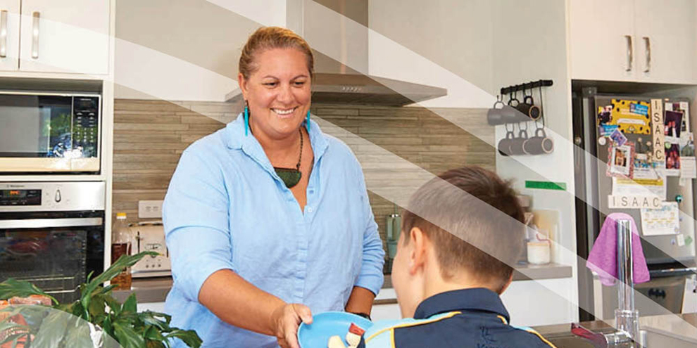 Rata hands a young person a plate of sliced apples. 